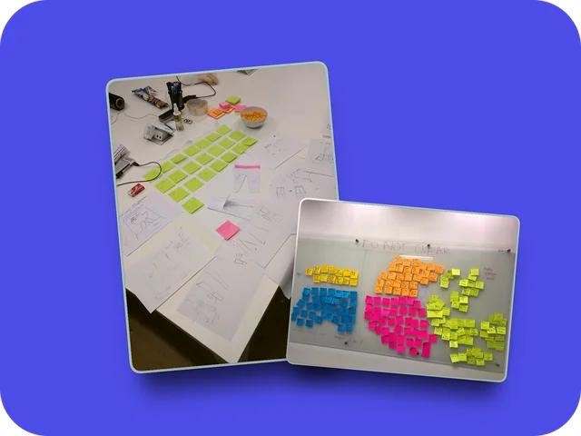 Sketches and sticky notes on a table, and an affinity map on a whiteboard